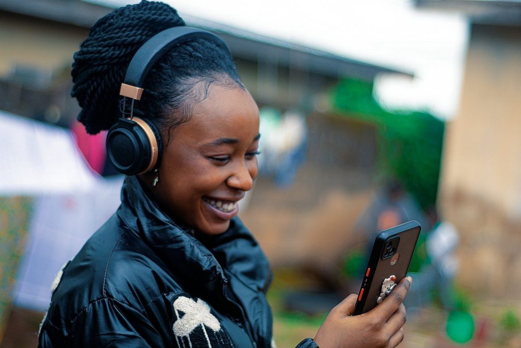 a person wearing headphones and holding a phone