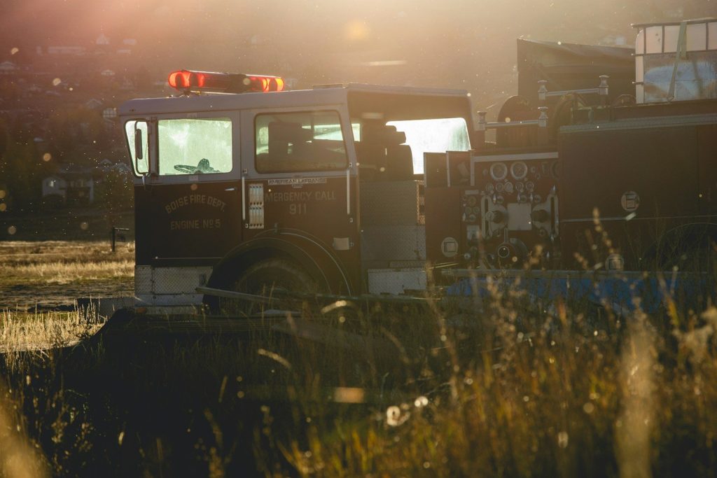 Fire truck with flashing lights at sunset