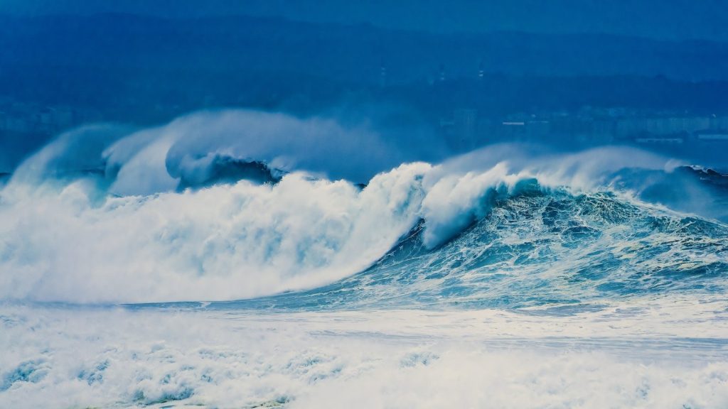 a large wave is breaking over the ocean