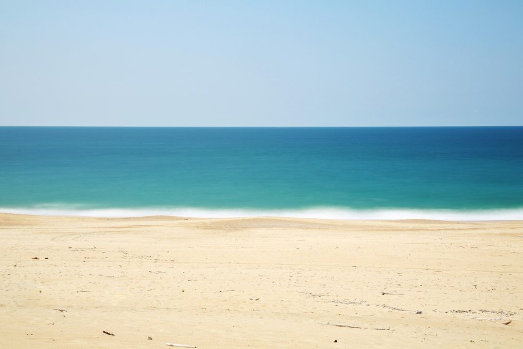 sandy beach with turquoise ocean