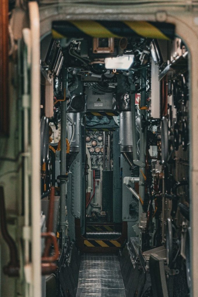 Interior view of a submarine's narrow corridor.