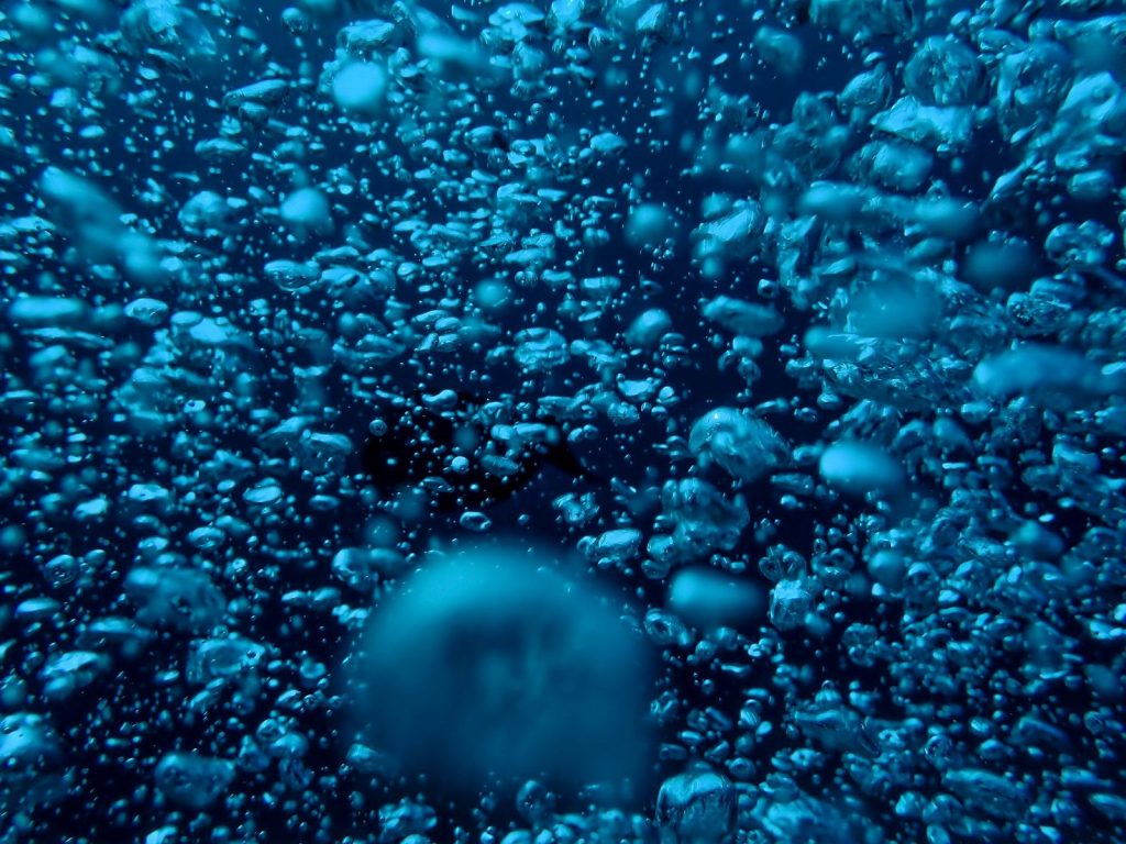 blue and white bubbles in water