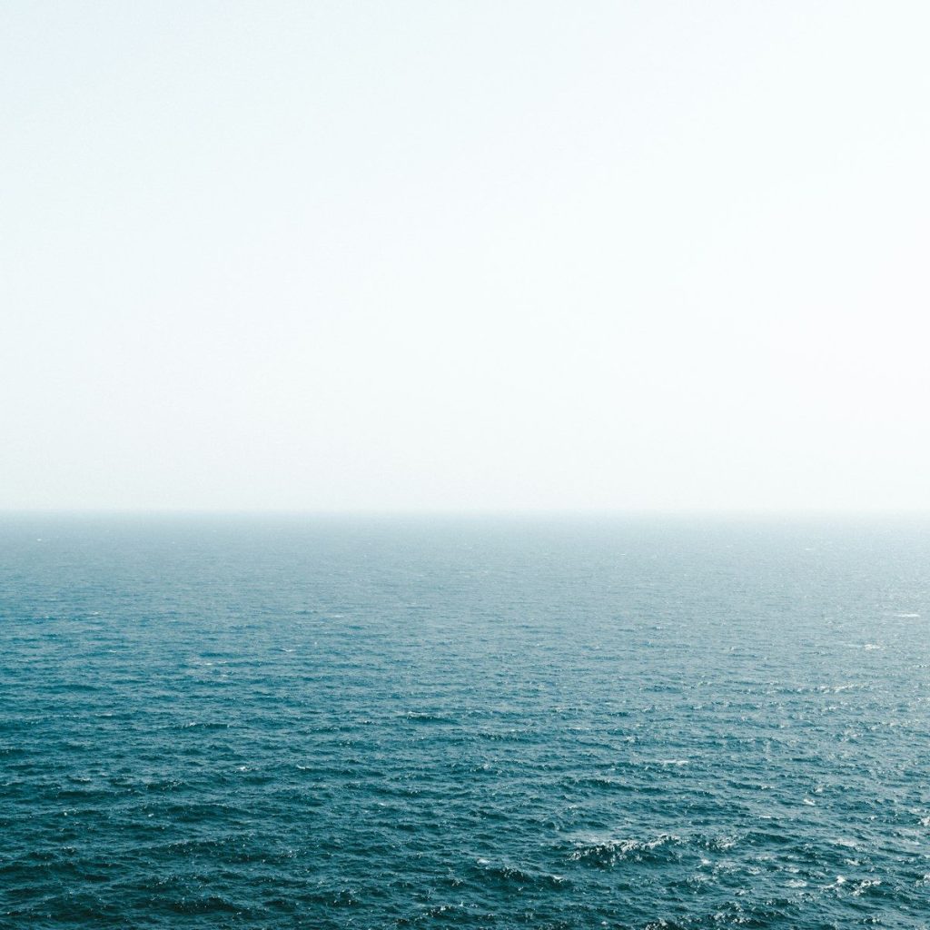 body of water under bright sky