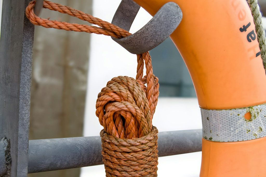 Coiled rope hangs from a metal hook