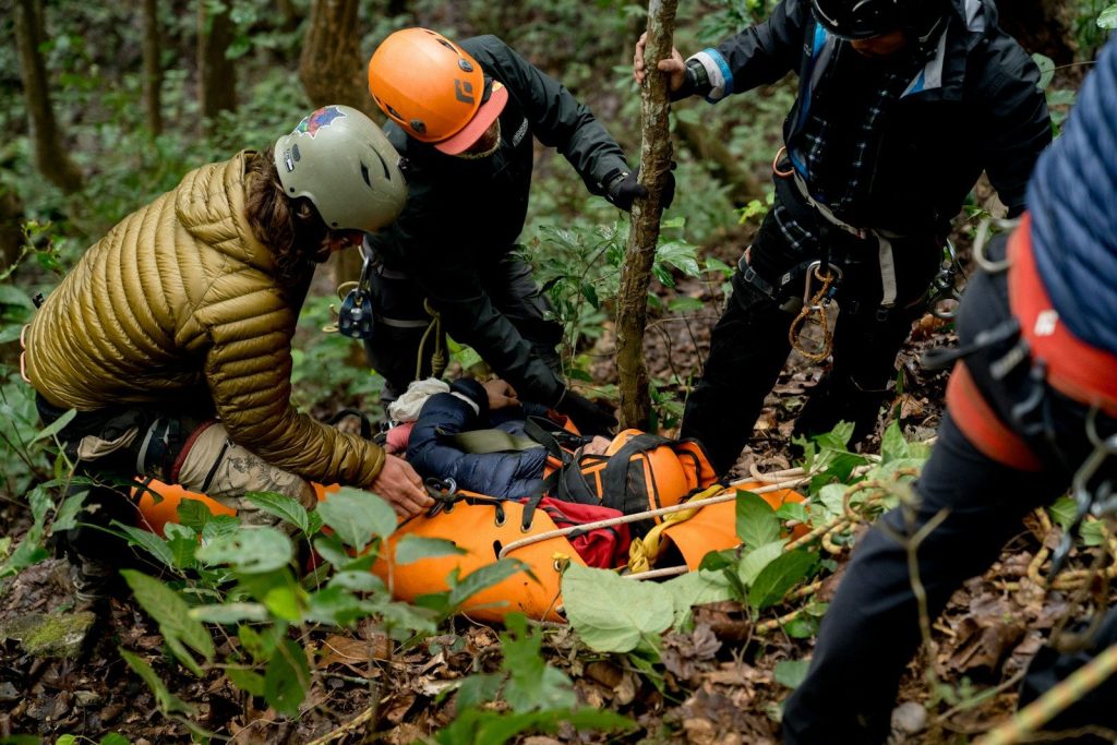 A group of people in the woods with helmets on