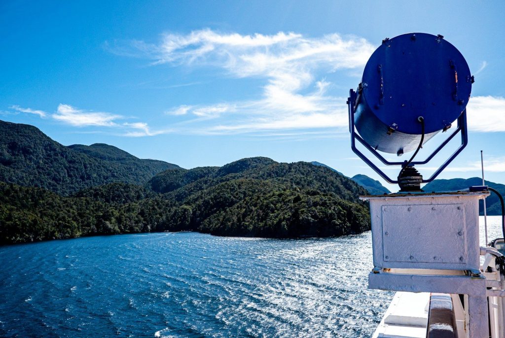 a view of a body of water with hills in the background