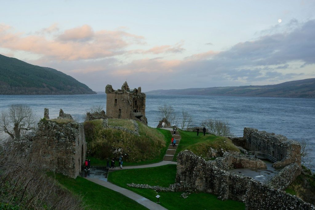 a castle on a hill overlooking a body of water