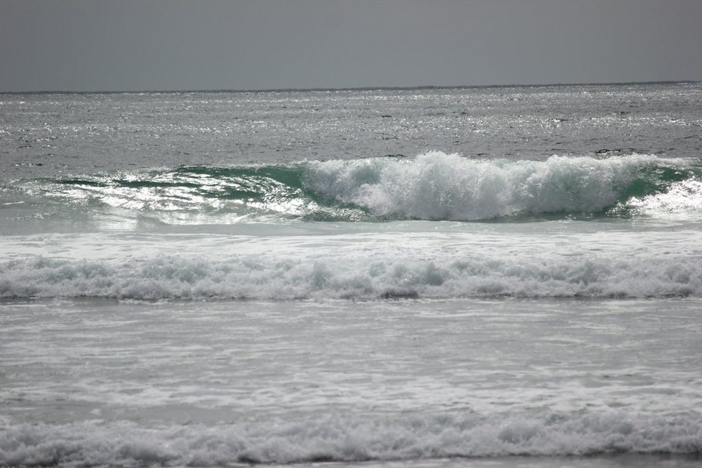 a person riding a surfboard on a wave in the ocean
