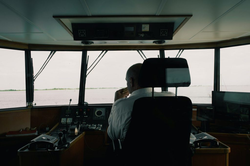 a man sitting in a boat on the water