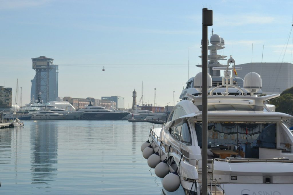 a boat docked at a marina with a city in the background